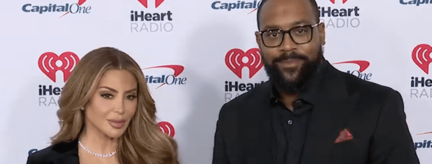 Two people at iHeartRadio event, smiling.